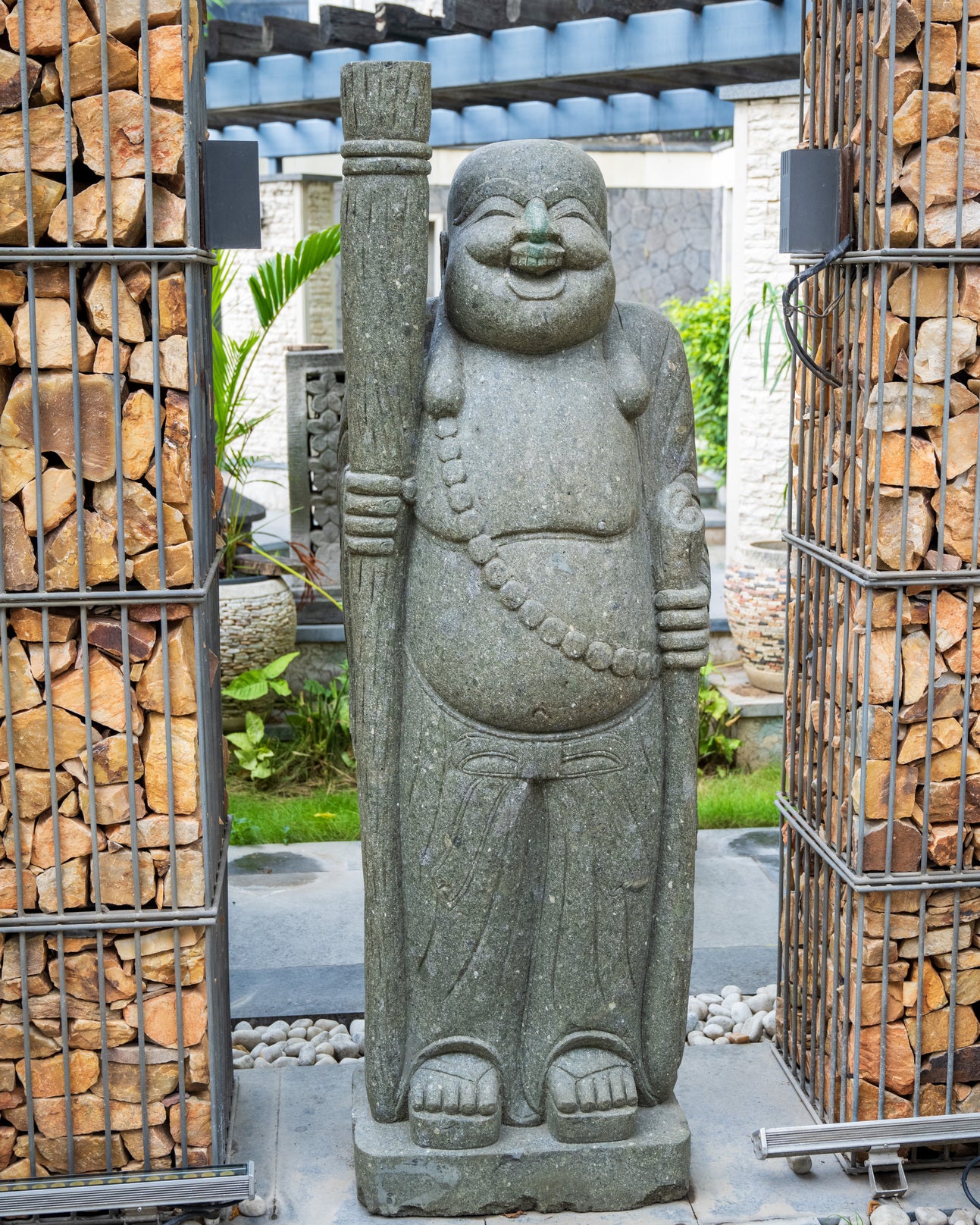 Happy monk elevated statue